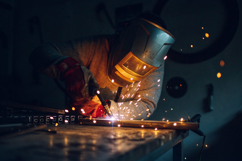 man worker welding metal with welding machine in a 2022 11 24 20 41 08 utc